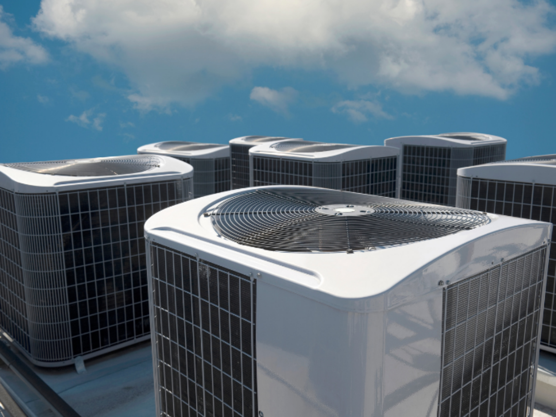 Several air cooling units are installed to the roof of a building.
