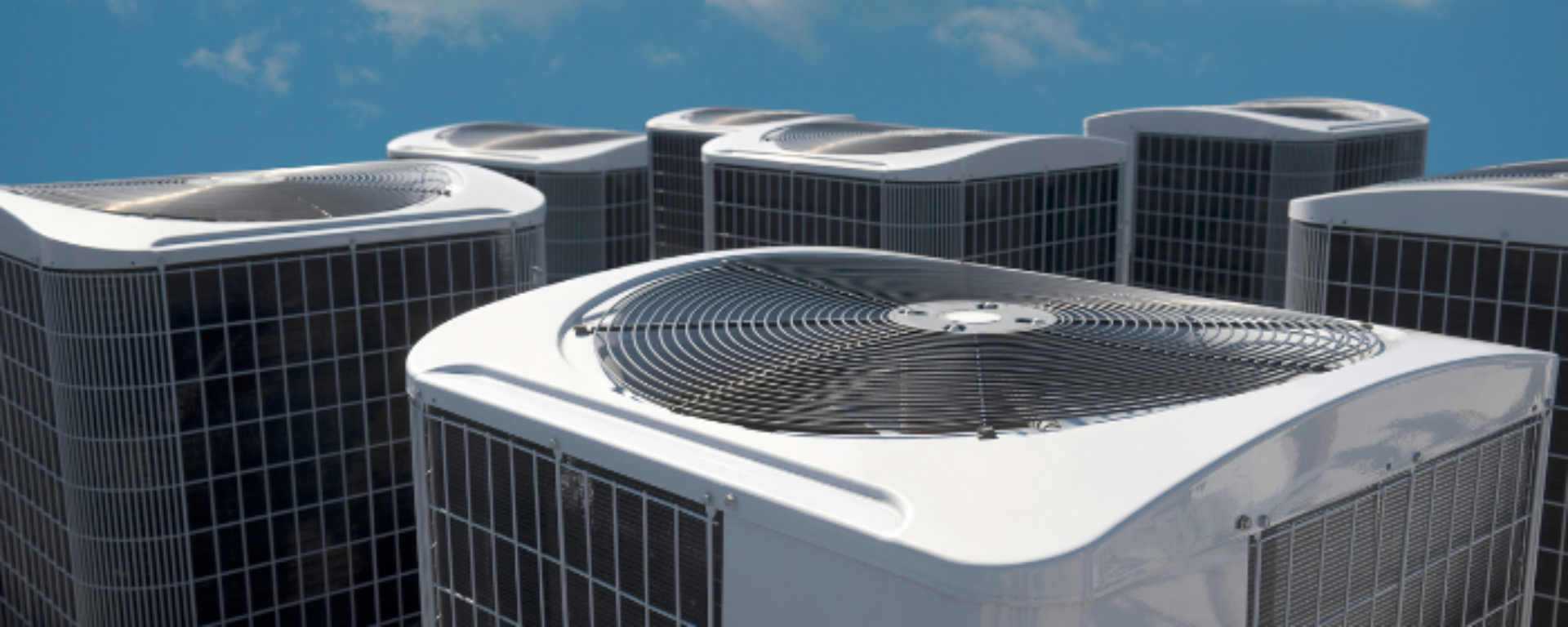 Several air cooling units are installed to the roof of a building.