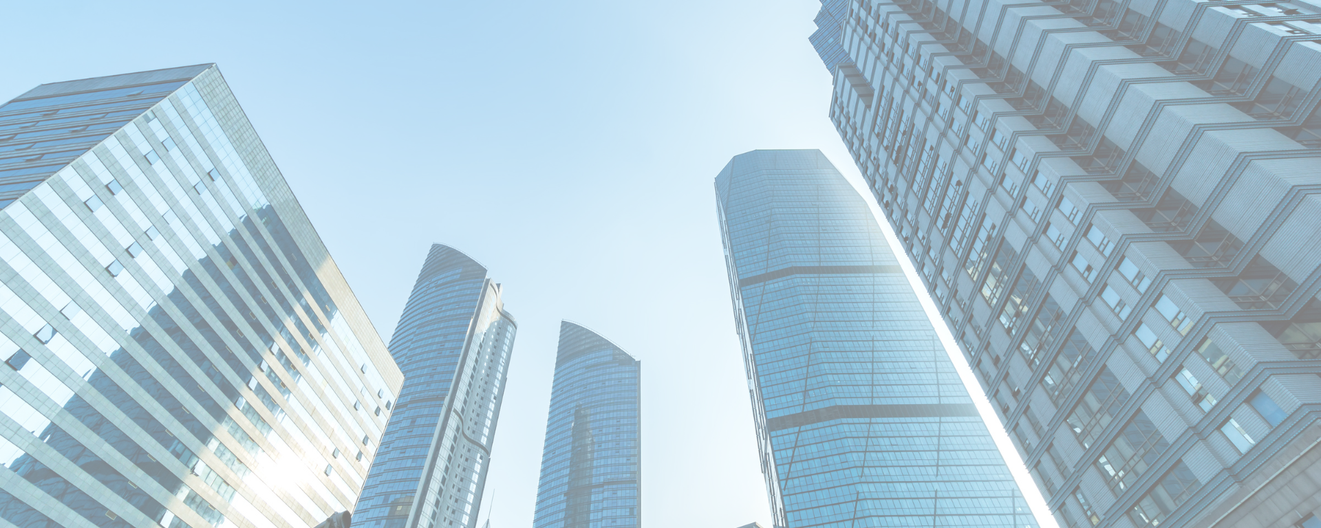 A view from the ground looking skyward of skyscrapers.