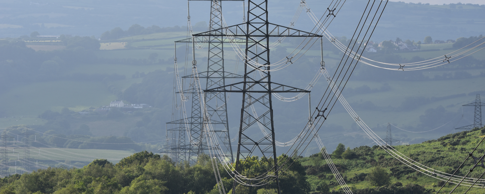 A line of pylons in the british countryside.