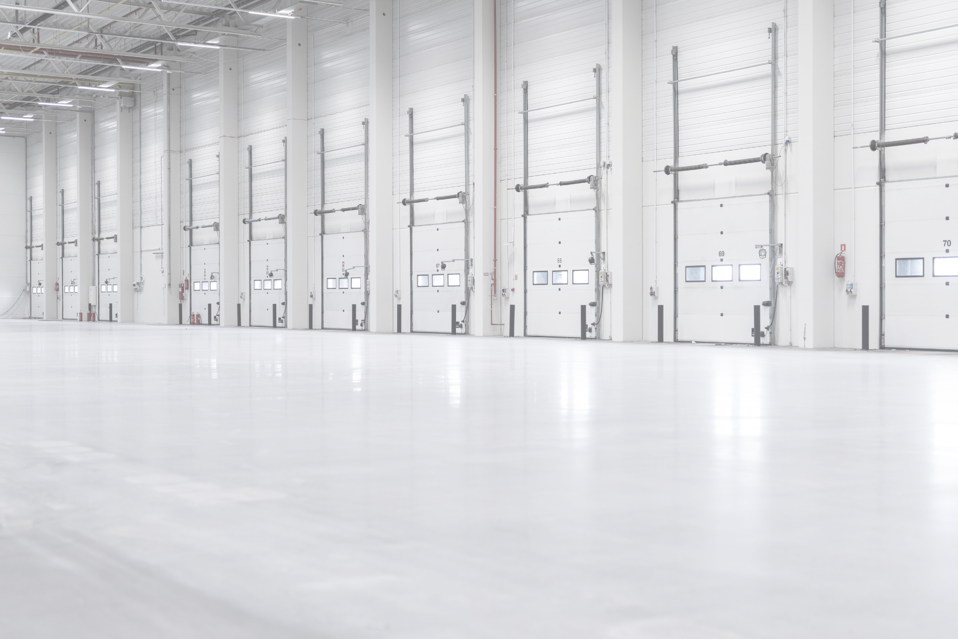 An internal view of a distribution warehouse and its dozens of large roller doors.